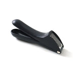 Garlic press kitchen tool placed neatly on a kitchen countertop