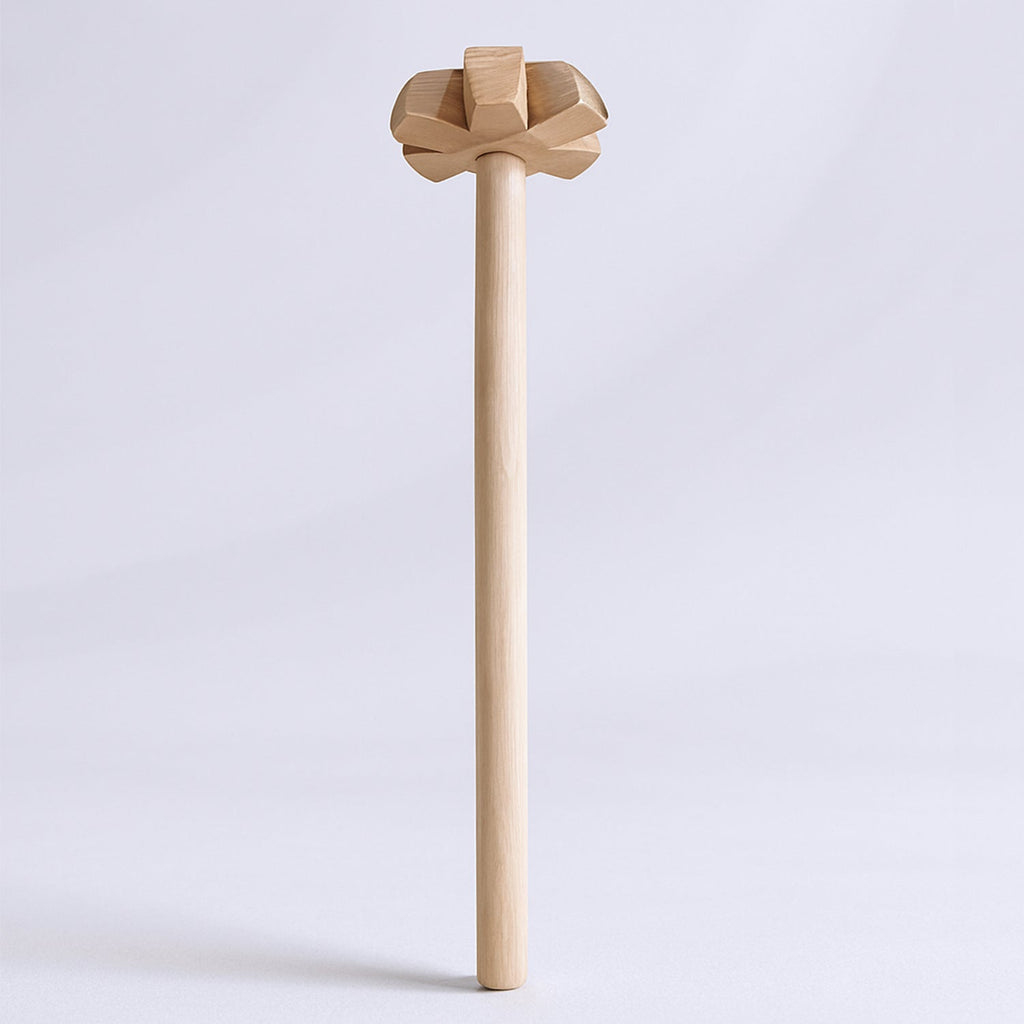 Traditional wooden blender blending spices and ingredients in a kitchen.