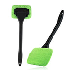 Person effectively wiping a car window with the microfiber windshield cleaner.
