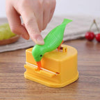 Demonstration of pressing button to dispense toothpick from bird dispenser