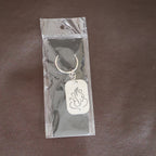 Back view of the Ganesh Metal Keychain, showing its smooth edges and premium finish.