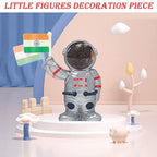 Solar powered astronaut figurine waving Indian flag on car dashboard