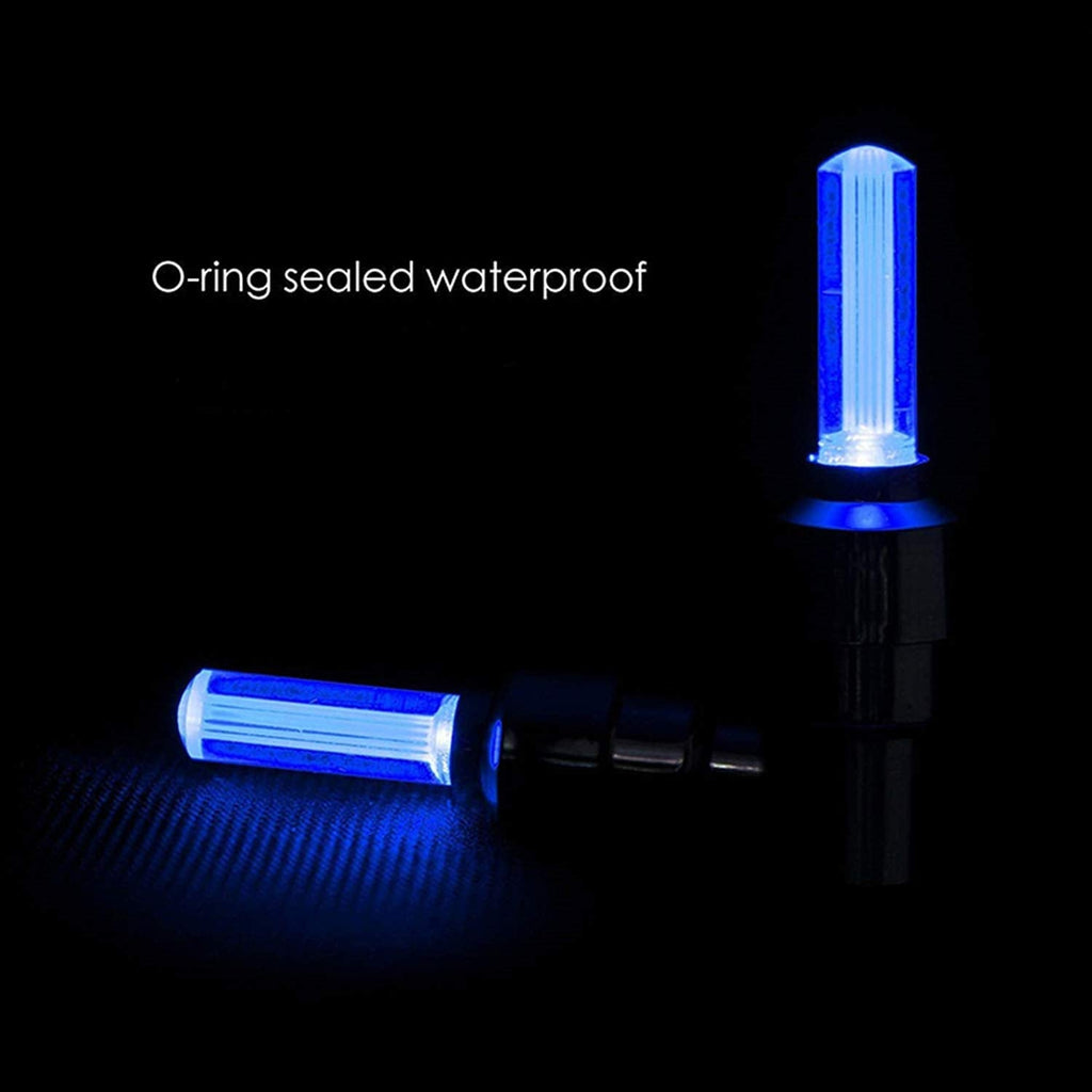 Mixed-color LED tire valve caps clearly illuminating a moving vehicle wheel.