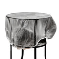 Thick transparent disposable plastic furniture cover protecting a sofa.