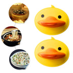 Bright yellow silicone duck-shaped pot holder in practical use