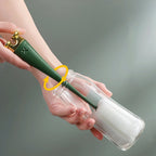 Silicone bottle cleaning brush with a long plastic handle and foam head for deep cleaning.