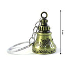 A metal temple bell keychain held in hand, illustrating its compact size and design.