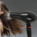Hair dryer in action, creating a sleek hairstyle for Indian hair.