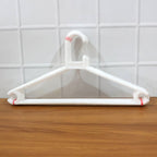 Dimensions diagram showing length, width, and height of plastic clothes hanger