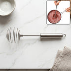 Steel whisk for eggs and cream mixing in kitchen