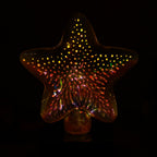 Star shape 3D illusion night lamp illuminating vibrant colors in a dark room