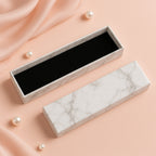 Luxury empty jewelry gift box with marble finish and black velvet interior, 21x5cm.