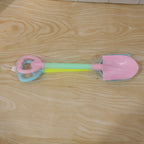 Close-up of colorful plastic sand digging tools for kids