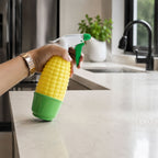 Decorative corn-shaped spray bottle used for watering indoor plants.
