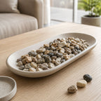 Decorative river pebbles in a vase and garden setting