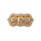 Studio shot of the golden Kankavati on a white background.