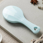 Detail view of the manual paddle massager showing steel balls.