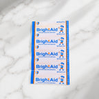 BrightAid medicated dressing strips in sterile packaging.