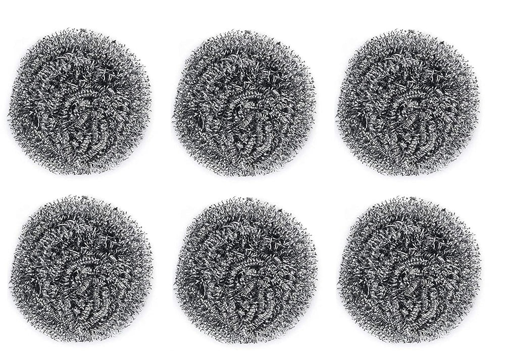Close-up of a long-lasting round stainless steel scrubber in hand.