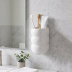 Wall-mounted caterpillar storage holder used for toothbrushes and toothpaste