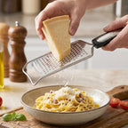Kitchen cheese grater in use for grating cheese or vegetables
