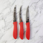Kitchen knife slicing a tomato