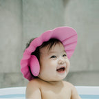 Water cascading over the adjustable baby shower cap, demonstrating effective eye protection