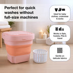 Portable washing machine in its compact, unfolded state, ready for use.