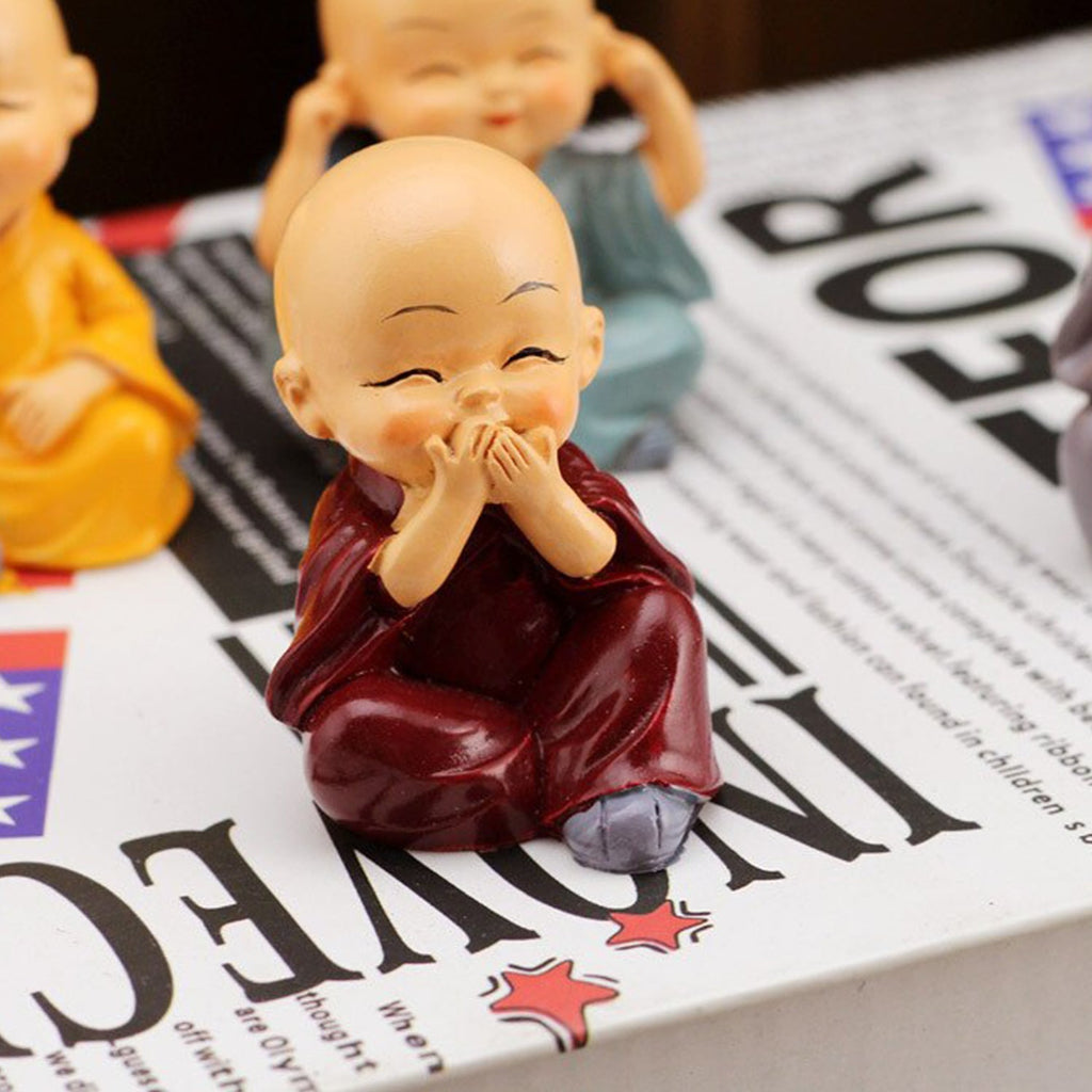 Baby Buddha showpiece set displayed on a shelf, adding a calming touch to the room.
