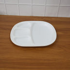 Plastic compartment plate in use with Indian meal served in sections