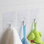 Set of stainless steel adhesive hooks displayed for kitchen organization.