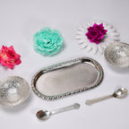 A beautiful serving set featuring two silver plated bowls and spoons, designed for traditional Indian hospitality.