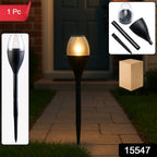 Solar garden light glowing warmly outdoors at night