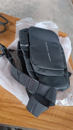 Anti-theft sling bag displayed hanging, featuring secure lock and water-resistant fabric