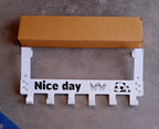 Full view of white heavy-duty over door hook hanger rack with 6 hooks
