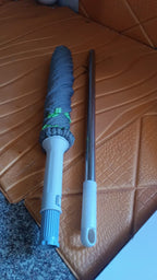 Self wringing mop's microfiber head close-up with cleaning debris trapped