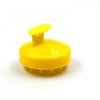 Scalp massager brush showing its compact and travel-friendly design.