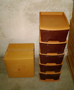 Full view of the brown 5-tier plastic modular drawer system against a plain background.