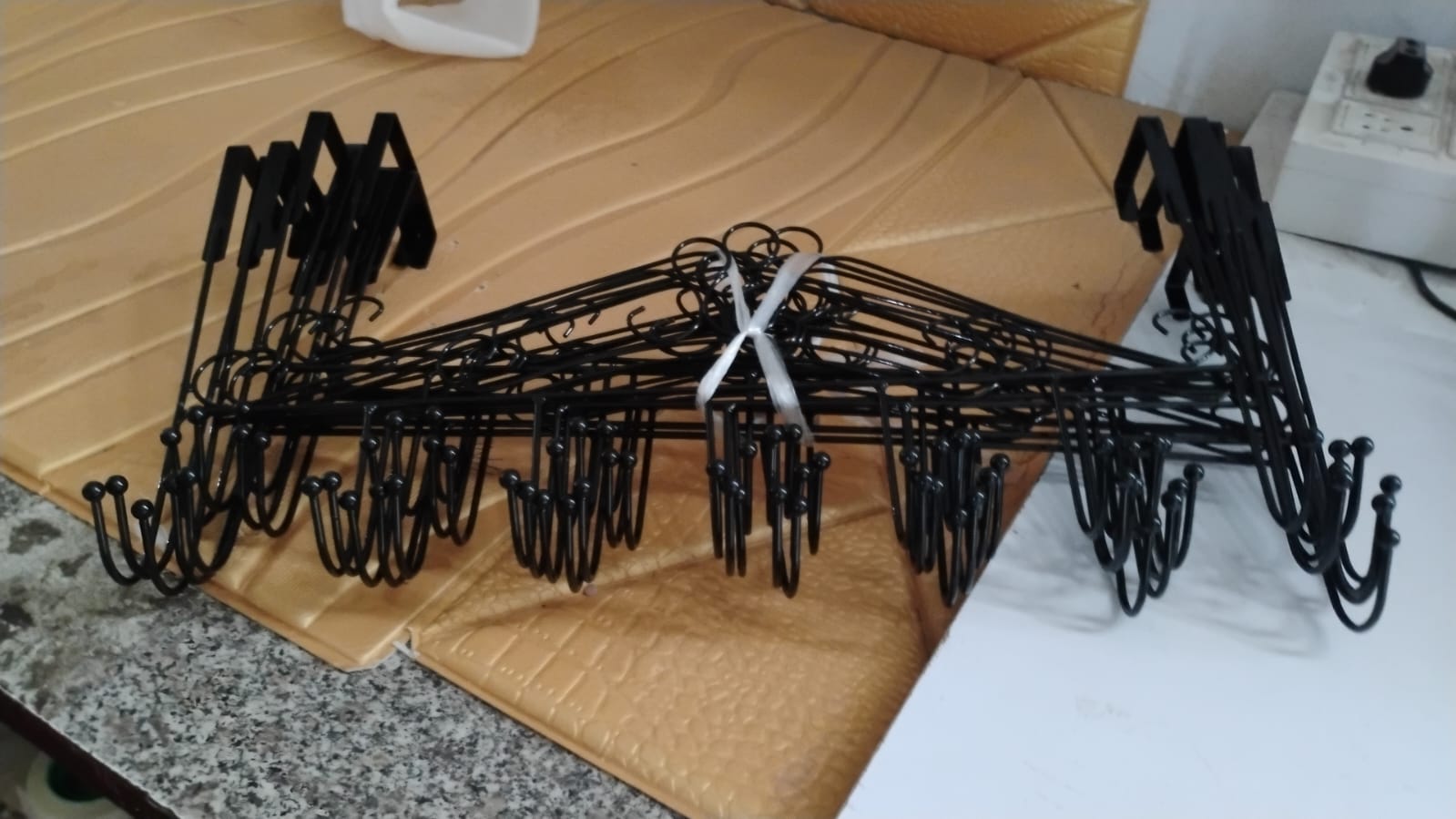 Lifestyle image of the Over Door Hanger Rack in use, creating tidy storage space.