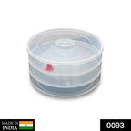 Side view of a white plastic 3 compartment sprout maker on a kitchen counter.