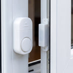 Security alarm sensor installed on a door frame