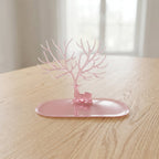 Base view of pink deer jewelry stand on table, India