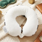 Plush cow print travel cushion for napping on journeys
