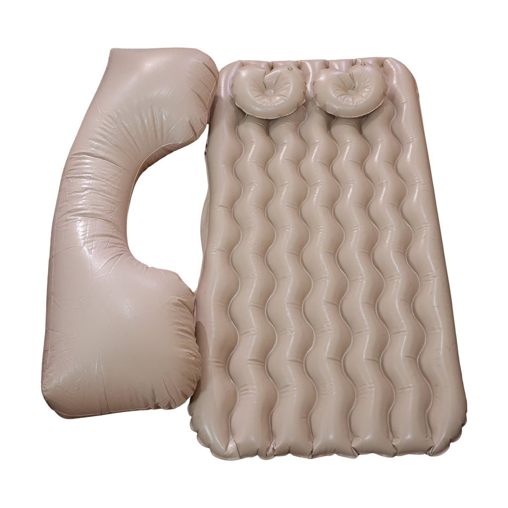 Inflatable car air mattress installed in back seat with pillows.