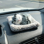 Adorable plush cat car ornament with a soft finish and closed eyes