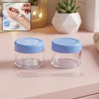 Empty plastic cosmetic cream jar set with spatula and blue lid