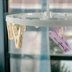 Close up of metal clips on clothespin drying rack with strong grip