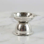 Compact decorative steel diya stand with sunflower design for rituals