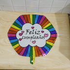Party decor with shiny Feliz Cumpleanos foil balloon