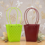 Close-up of curved handle and snap-button detail on flower bag